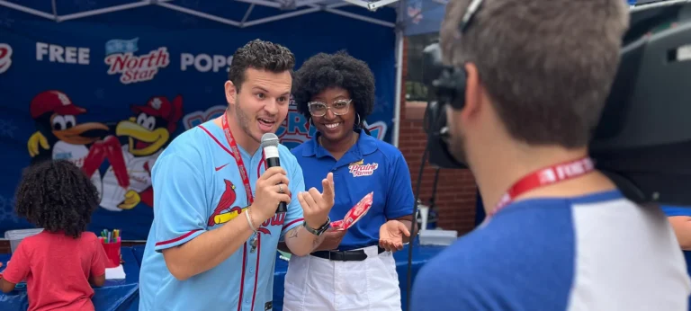 reporter interviewing a volunteer at the prairie farms ice cream sundays event